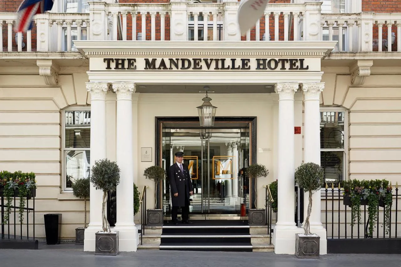 a man standing in the doorway of a hotel at The Mandeville Hotel in London